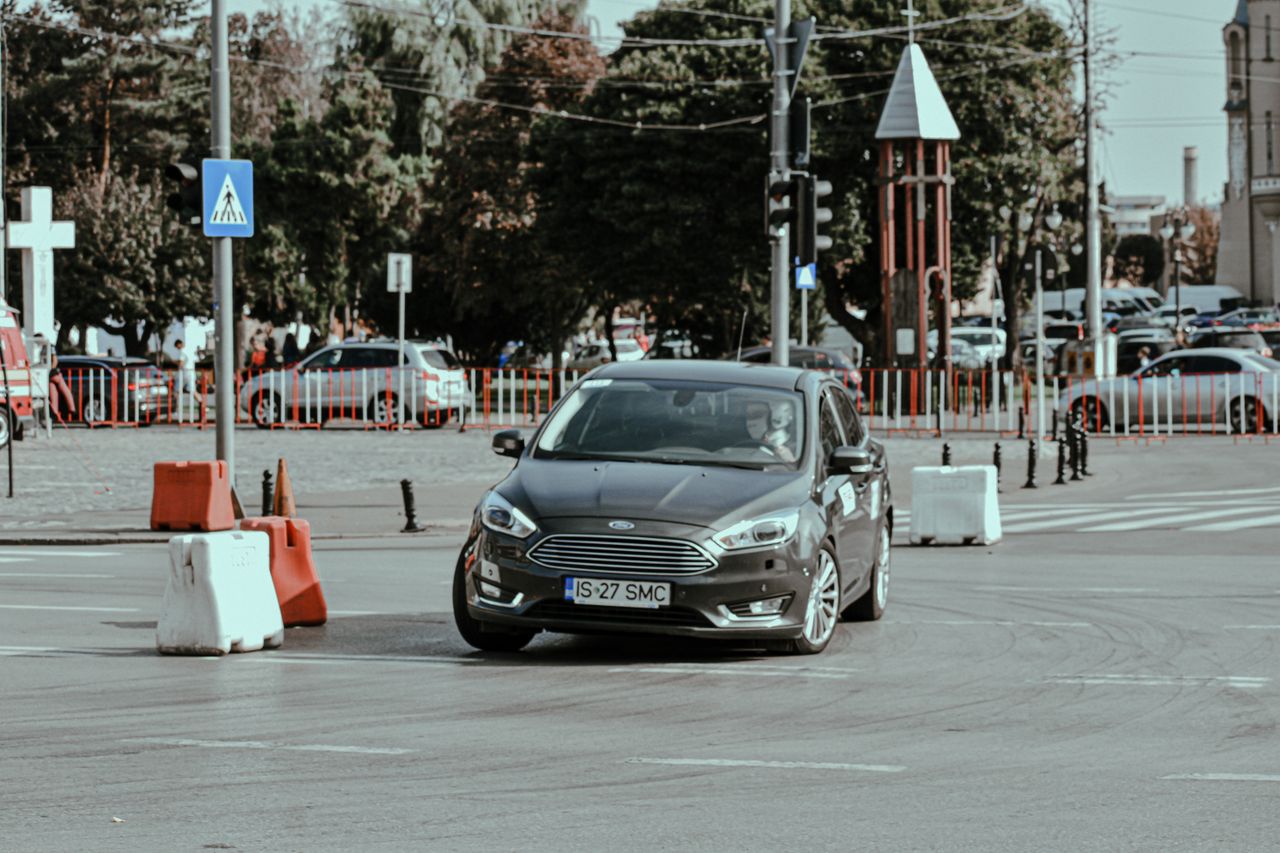 gallery-4 Rally racing car driving fast while turning on asphalt roadway in modern city